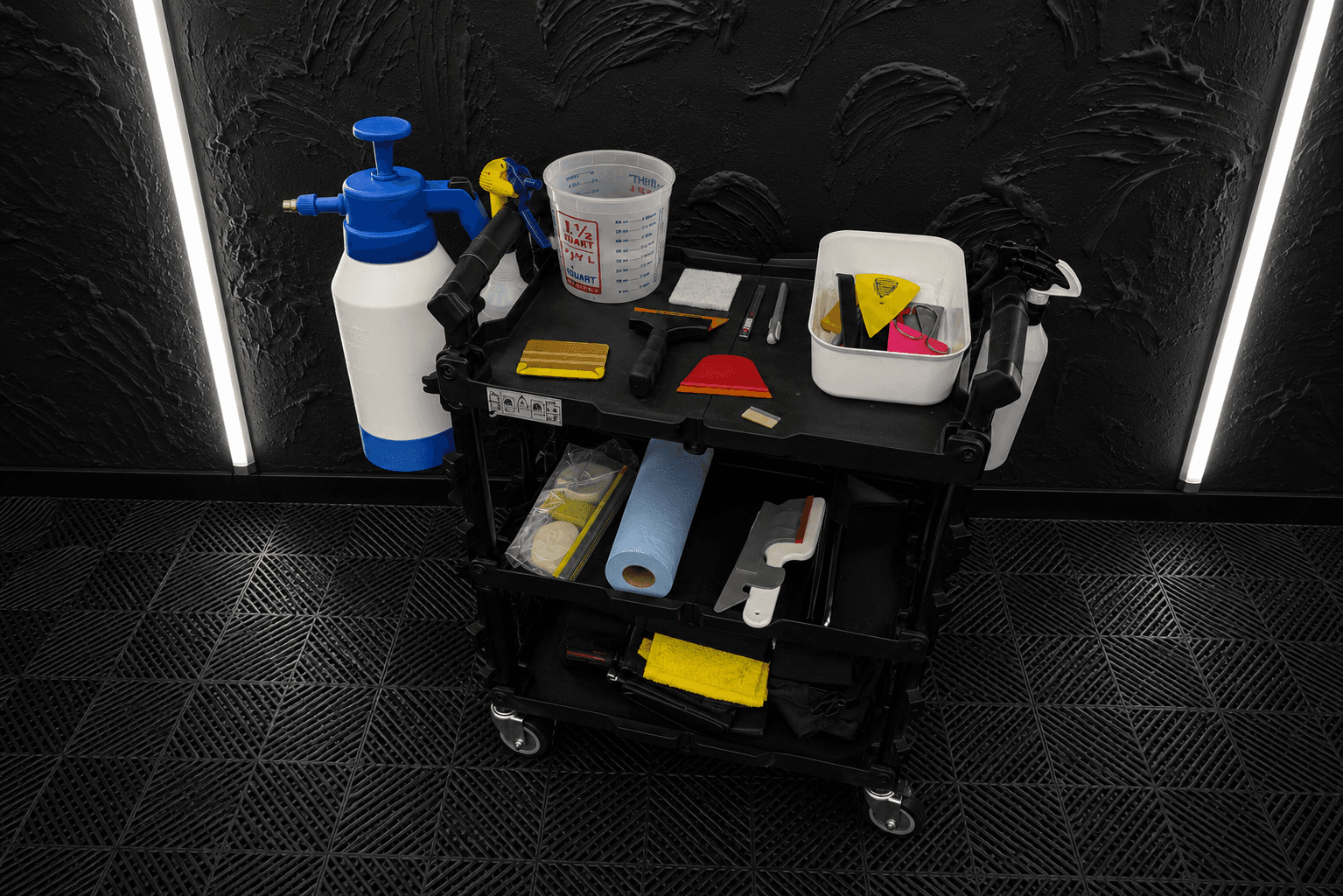 Professional window tint installation tools and supplies prepared inside the studio.